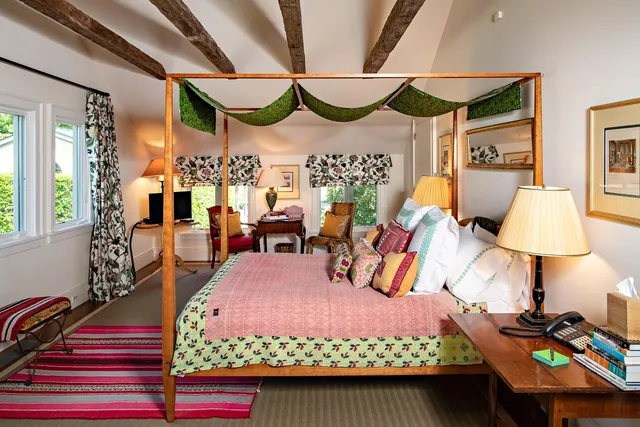 a bedroom with furniture and a mirror