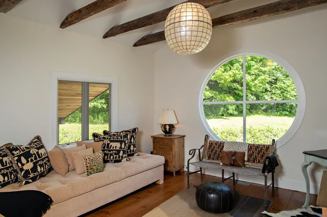 a view of a patio with table and chairs and a large tree