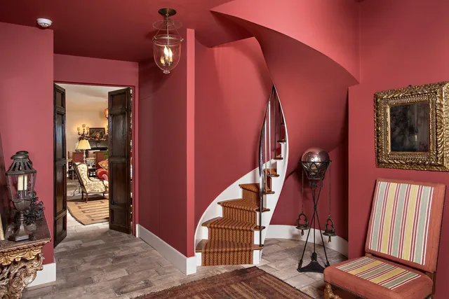 a living room with bookshelf and a fireplace