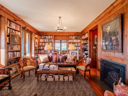 a living room with table and chairs
