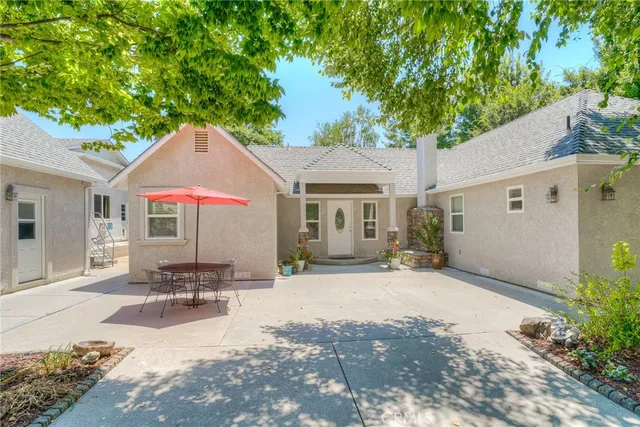 a front view of a house with a tree