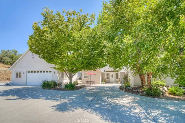 a front view of a house with outdoor seating and a potted plant