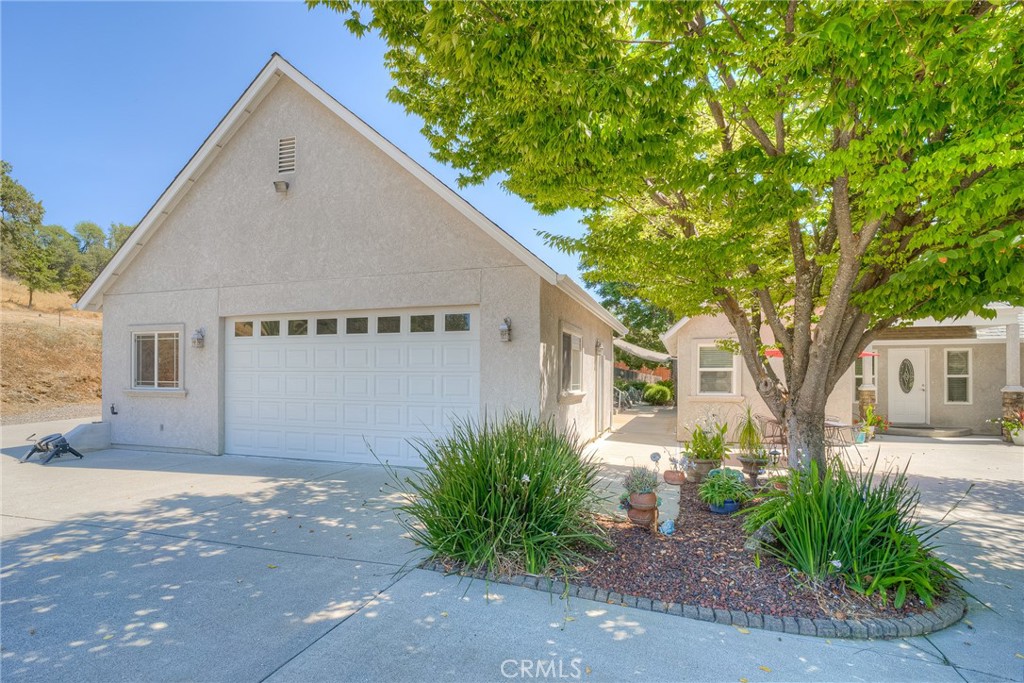 6060 Miners Ranch Road Oroville, CA 95966 - Photo 36 of 66 a view of a white house next to a road and yard
