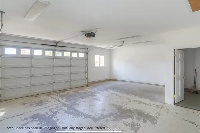 an aerial view of a house with a yard and covered with wooden fence