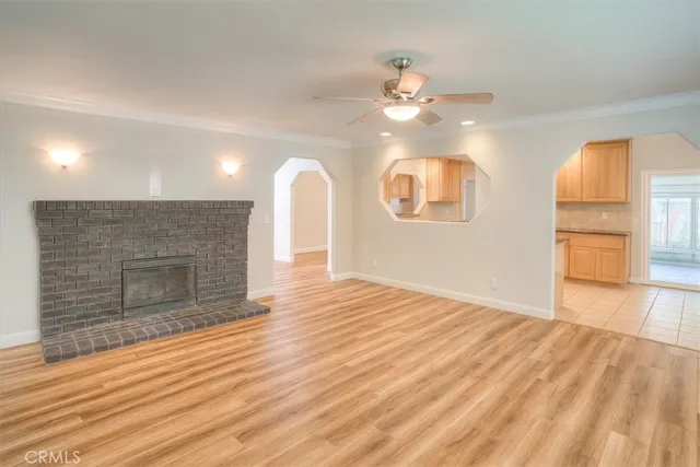 a view of a kitchen with furniture and wooden floor