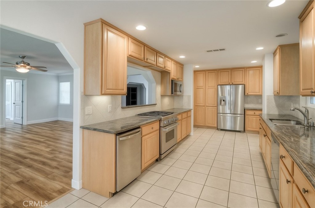 6060 Miners Ranch Road Oroville, CA 95966 - Photo 9 of 66 a kitchen with stainless steel appliances granite countertop a refrigerator and a sink