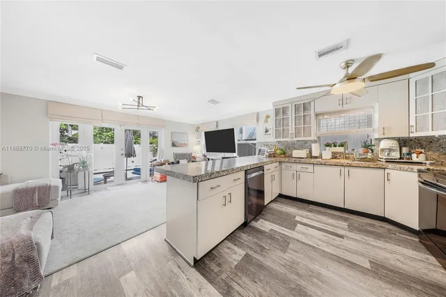 a kitchen with sink cabinets and window