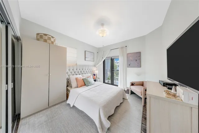 a bedroom with a bed and a flat screen tv