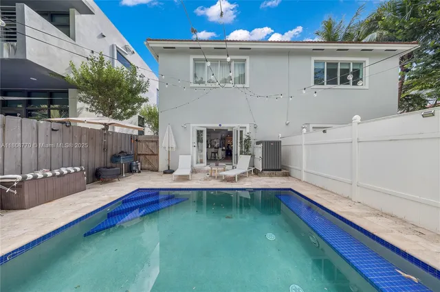 a house view with swimming pool in front of it