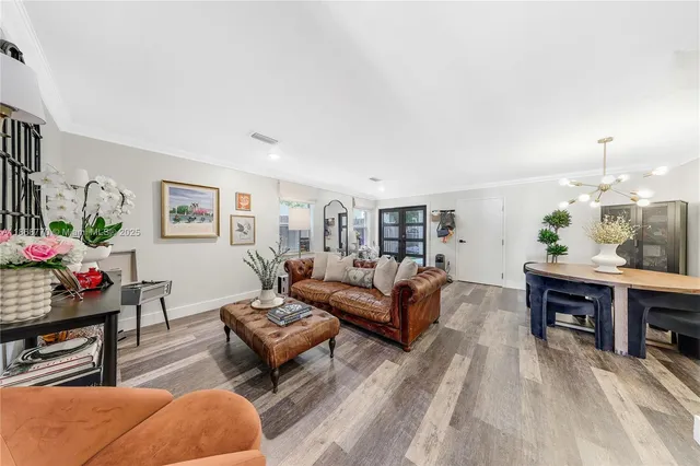 a living room with furniture a rug and a table