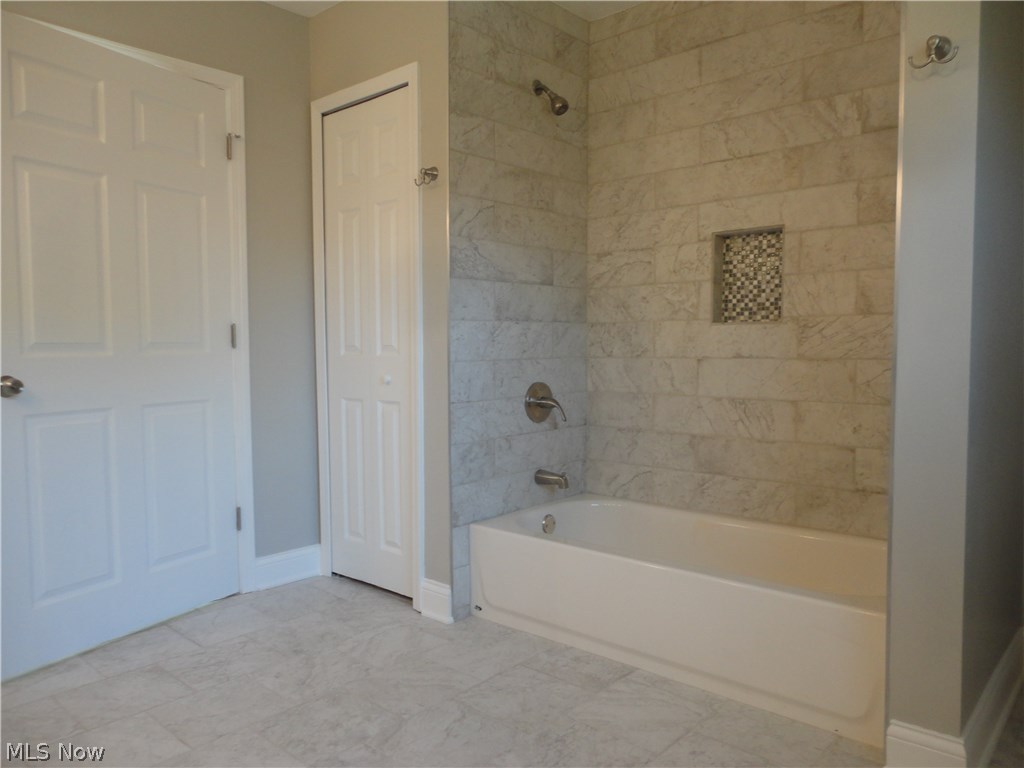 19646 Prospect Road Strongsville, OH 44149 - Photo 18 of 32 Master bath tub with tiled walls and plenty of storage.