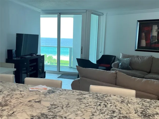 a living room with furniture a couch and a flat screen tv