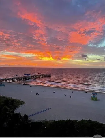 a large bed sitting in a bedroom next to a large window with a balcony