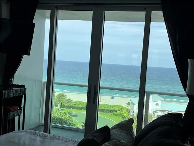 a bedroom with a large bed and a large window