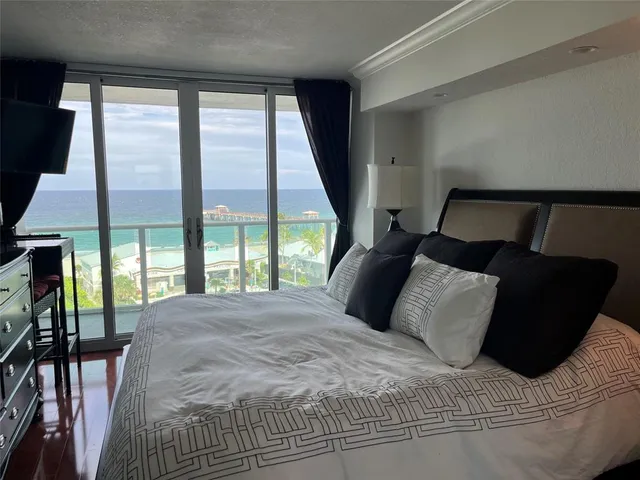 a living room with furniture window and a flat screen tv