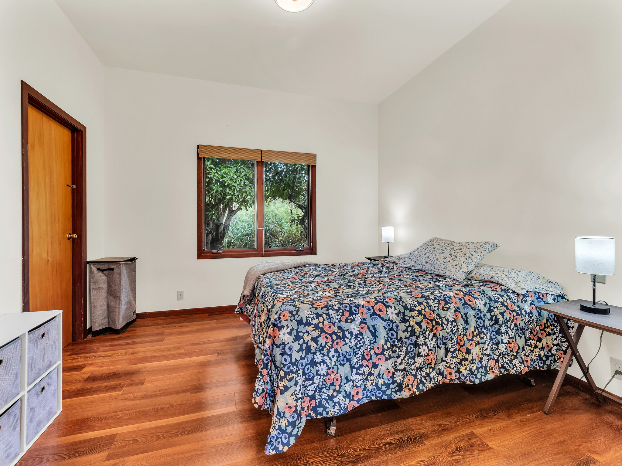 94-1769 Amepela Road Naalehu, HI 96772 - Photo 13 of 29 a bedroom with a bed and wooden floor
