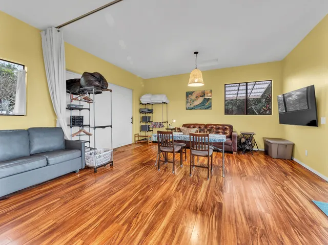 a dining room with furniture and wooden floor