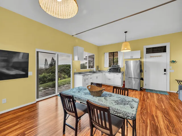 a view of a dining room with furniture wooden floor and chandelier