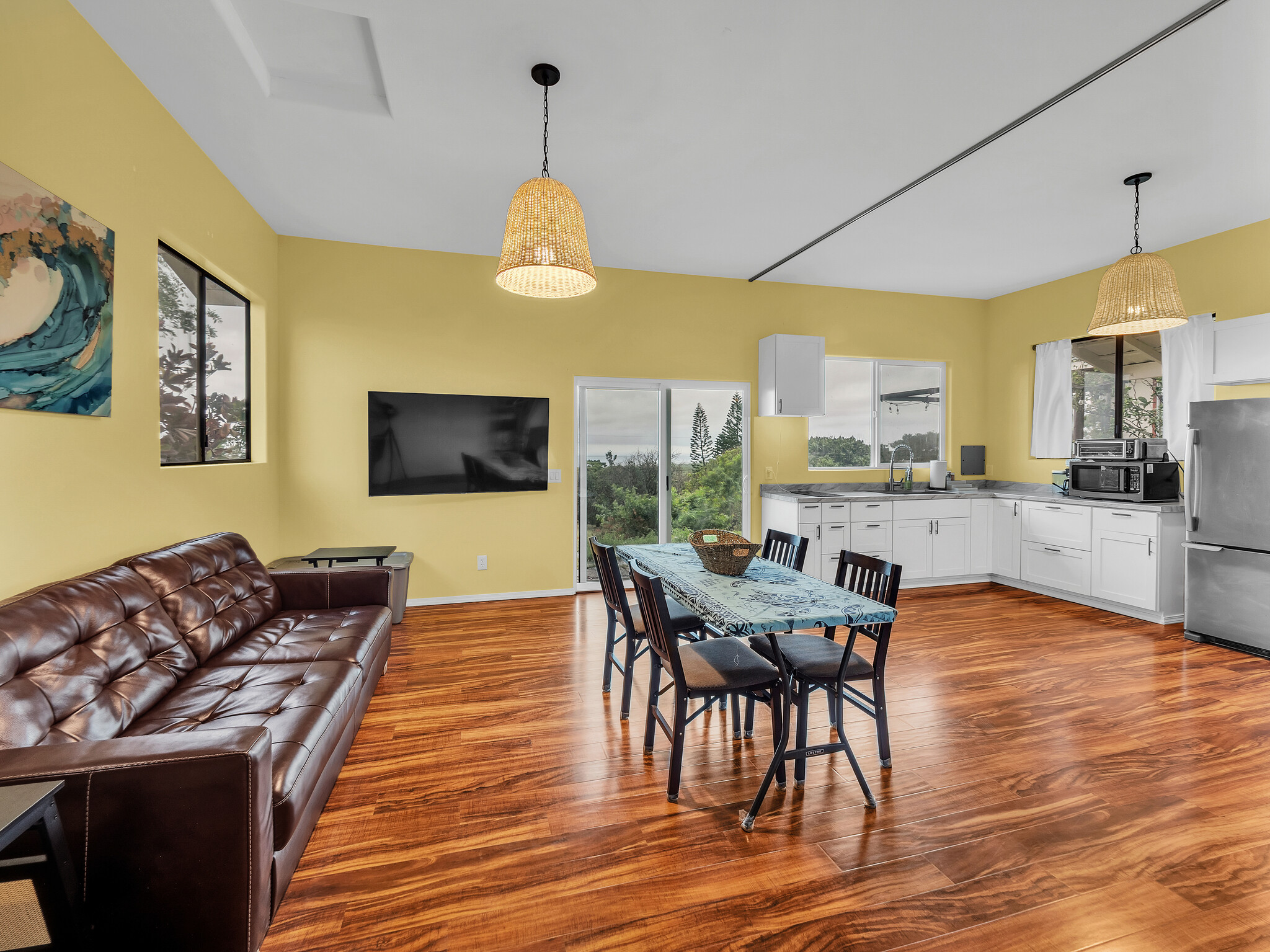 94-1769 Amepela Road Naalehu, HI 96772 - Photo 22 of 29 a view of a dining room with furniture wooden floor and chandelier