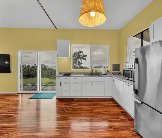 a kitchen with stainless steel appliances a stove a refrigerator and a sink