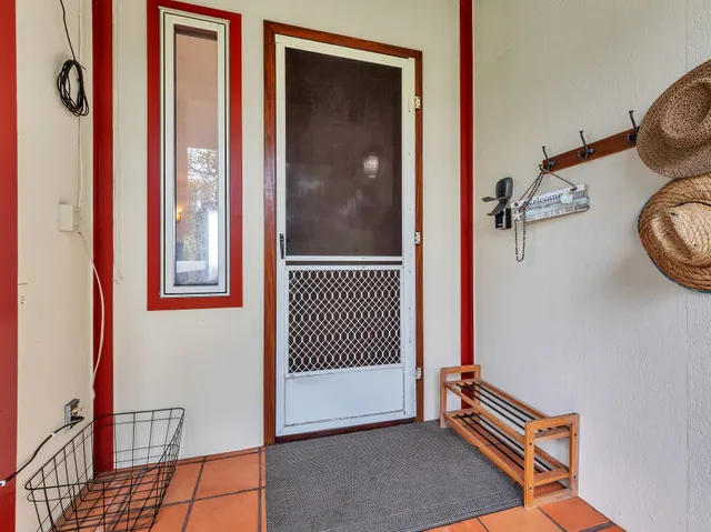 a living room with furniture floor to ceiling window and a flat screen tv