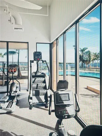 a living room with furniture and a floor to ceiling window