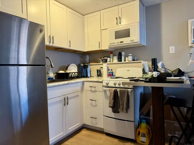 a kitchen with stainless steel appliances granite countertop a refrigerator stove a sink and dishwasher