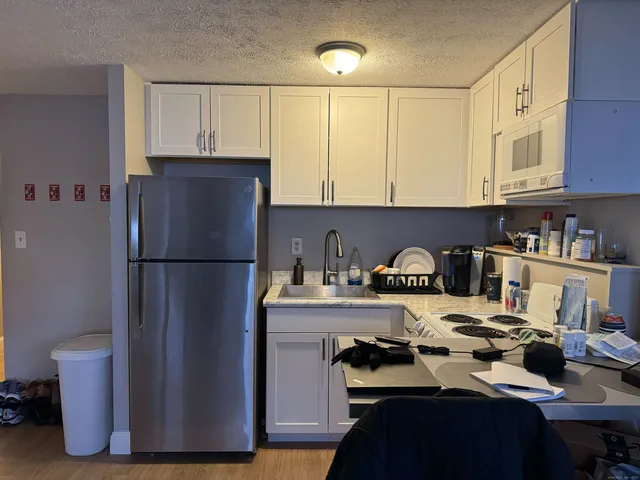 a kitchen with a refrigerator and a stove