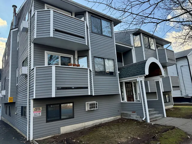 a view of a white house with large windows