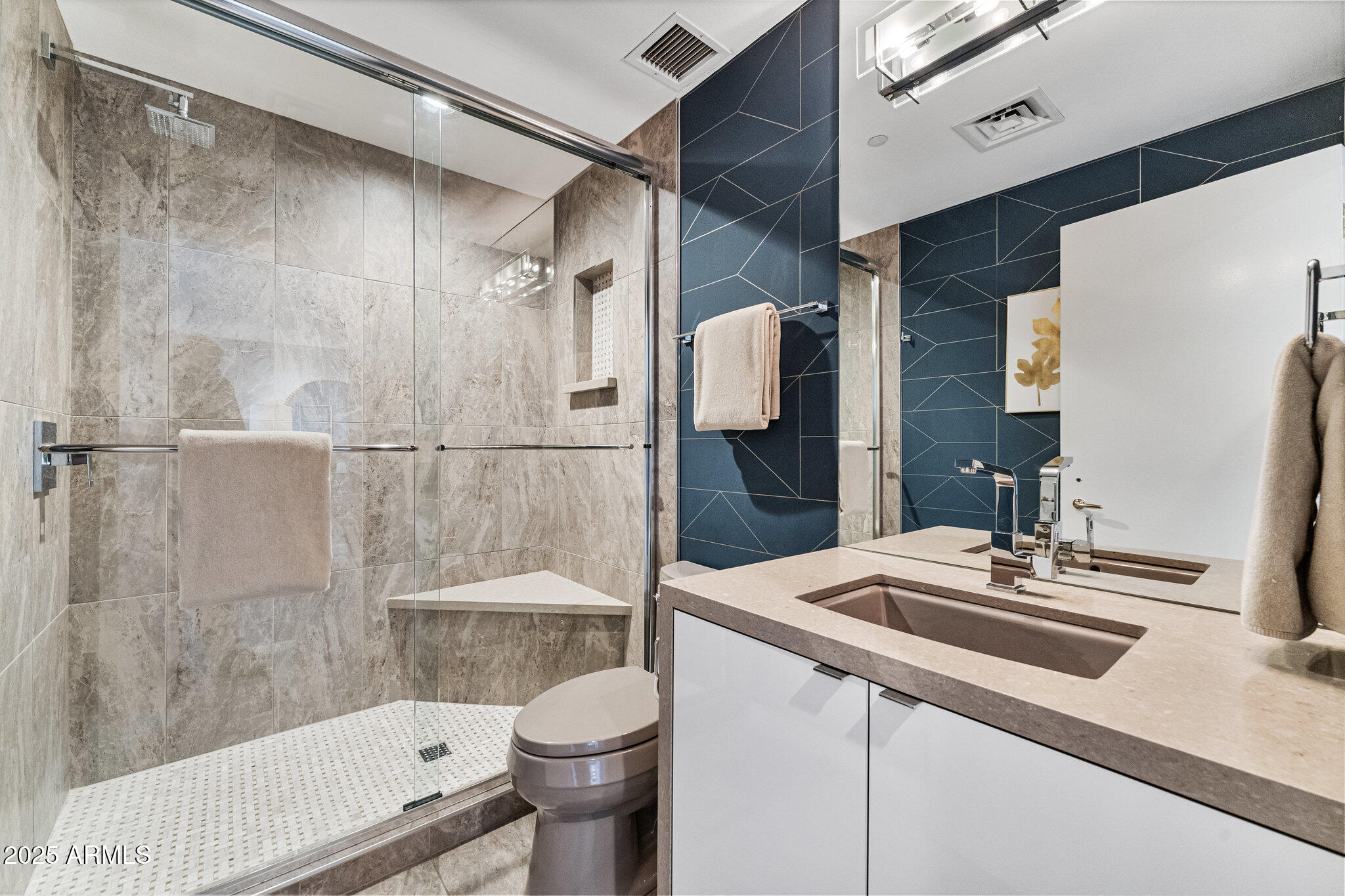 1040 East Osborn Road, Unit 1103 Phoenix, AZ 85014 - Photo 34 of 49 a bathroom with a sink a toilet and shower