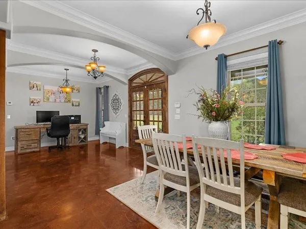 a view of a dining room with furniture and a chandelier