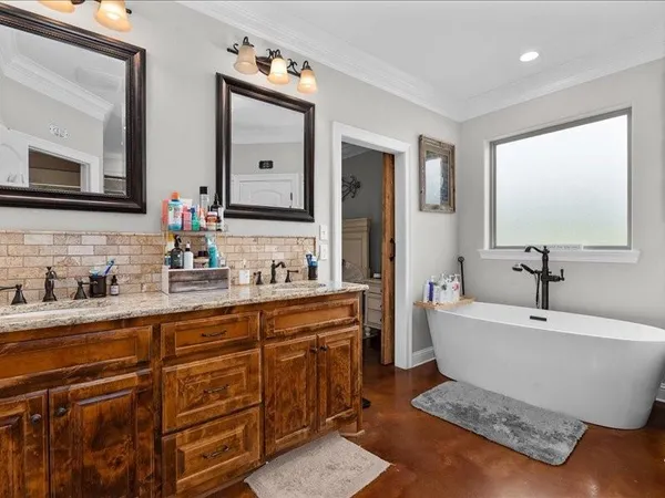 a bathroom with a bathtub a sink and a mirror