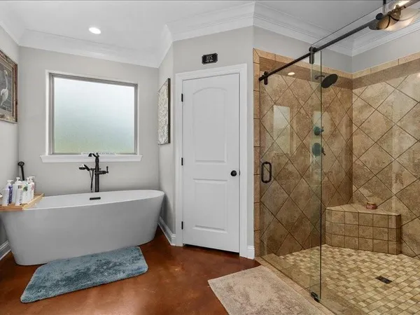 a spacious bathroom with a bathtub and shower