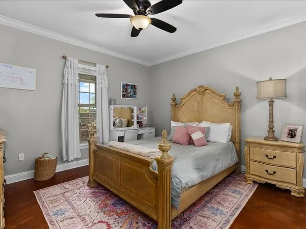 a bedroom with a bed and wooden floor