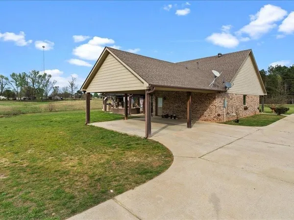 a view of a house with yard and a garden