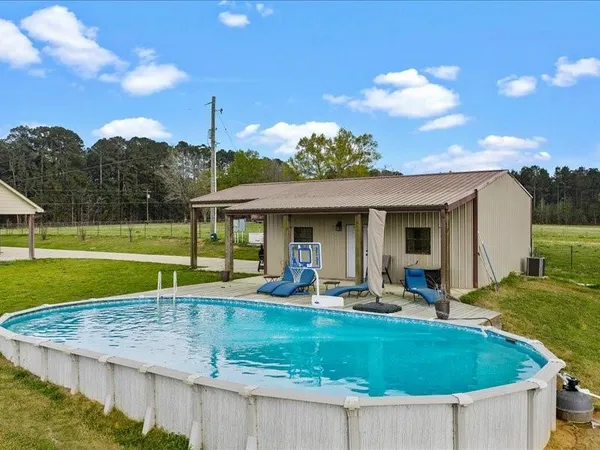a view of a house with a backyard porch and sitting area