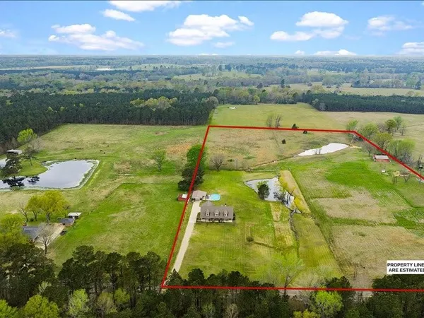 an aerial view of residential houses with outdoor space and swimming pool