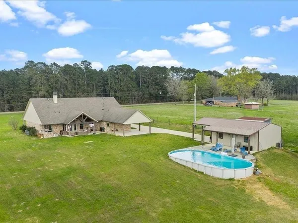 a view of a golf course with a garden and fire pit