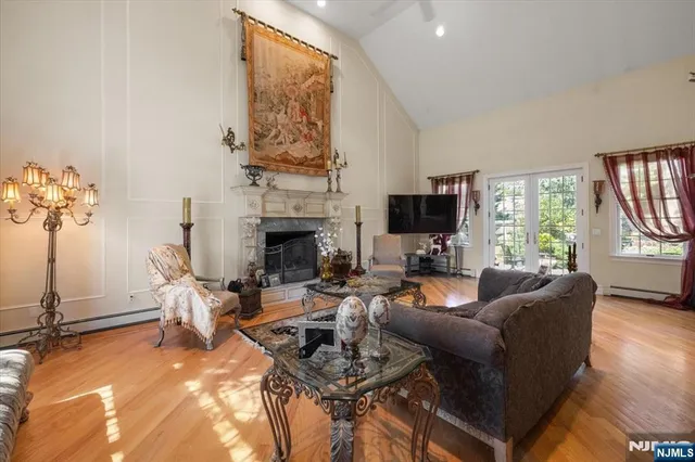 a living room with furniture a fireplace and a flat screen tv