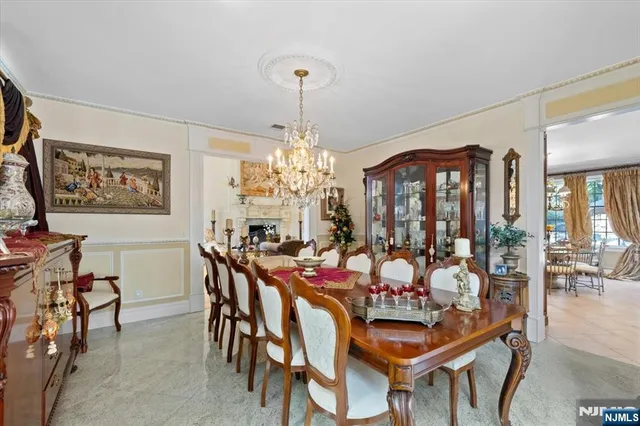 a view of a dining room with furniture and chandelier