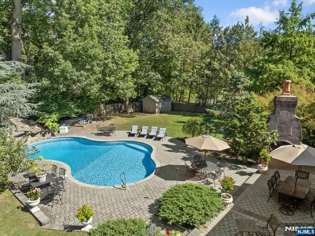 a view of a backyard with swimming pool