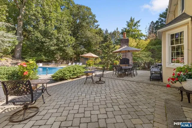 a view of a patio with dining table and chairs and potted plants