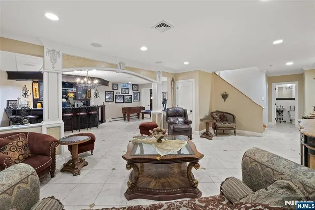 a living room with furniture and view of kitchen