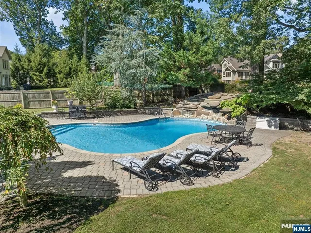 a view of a backyard with plants and patio