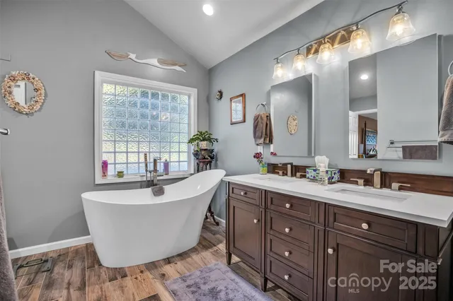 a spacious bathroom with a bathtub sink and mirror