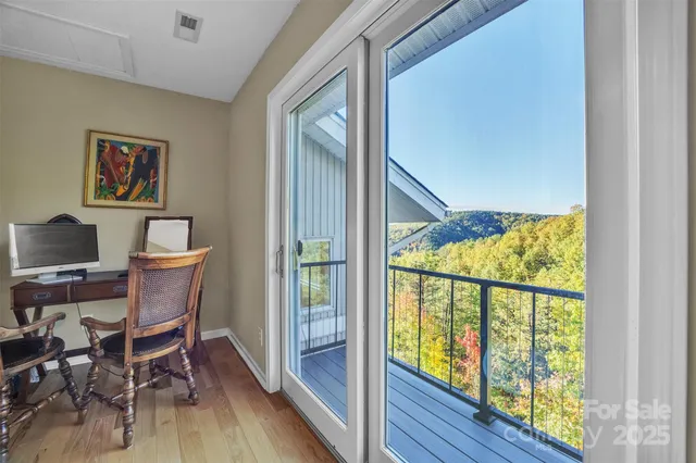 a view of a workspace with furniture and a window