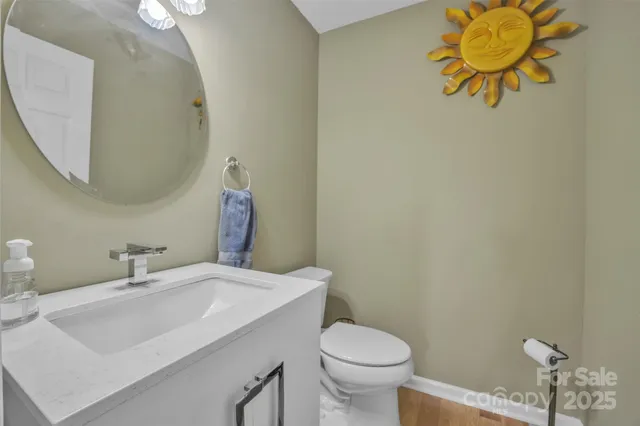 a bathroom with a sink mirror and toilet