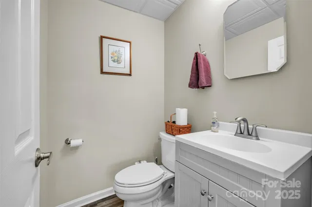a bathroom with a sink mirror vanity and toilet