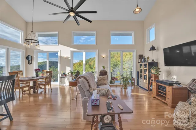 a living room with furniture wooden floor and a flat screen tv