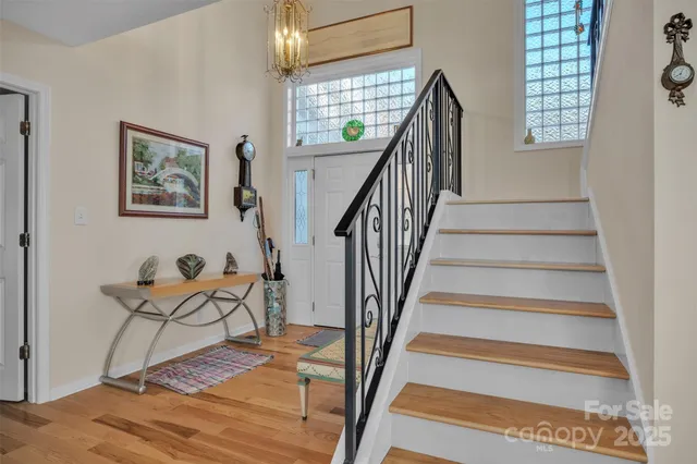 a view of entryway and hall with wooden floor